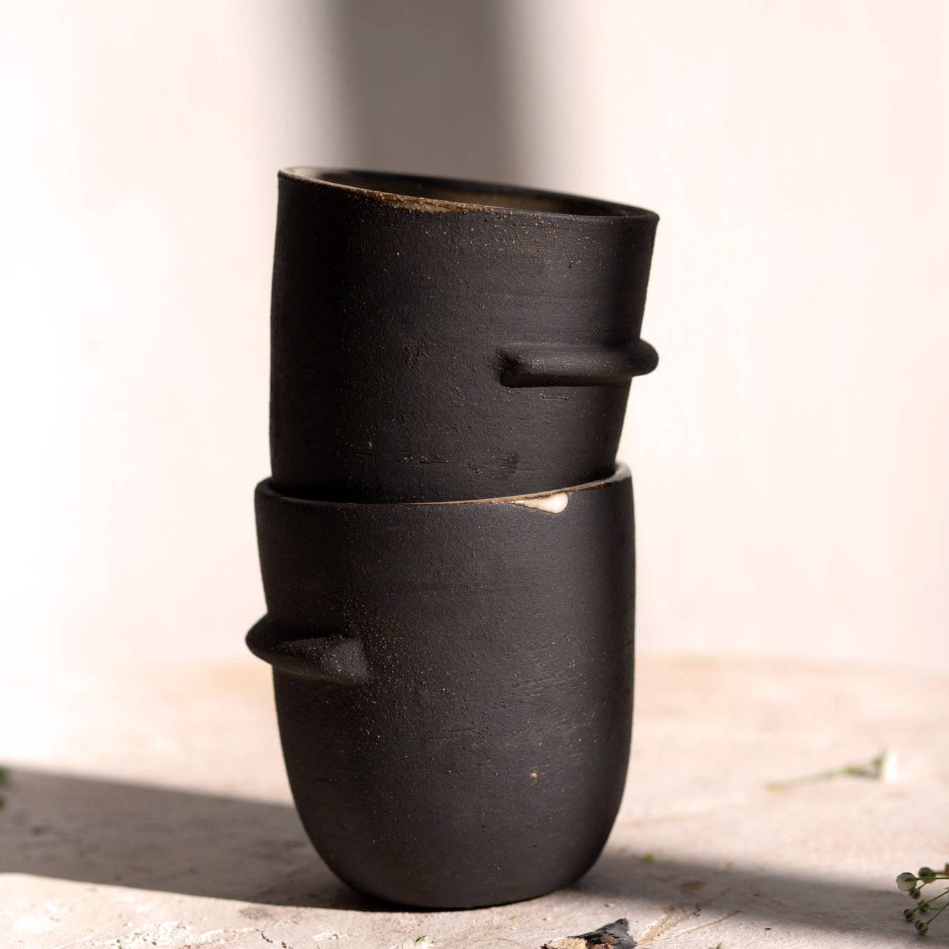good hearted woman / Sleek tumbler featuring a ledge halfway round. Perfect for small drinks and small hands. Raw black stoneware exterior, white glazed interior. Handmade in Denver, CO.