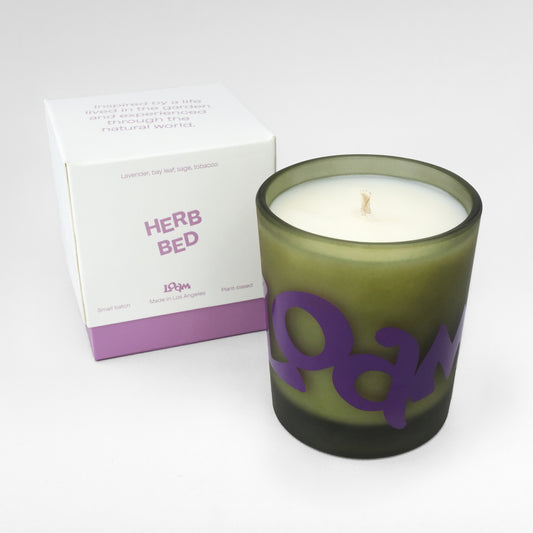 Herb Bed brings home the magical woody and herbaceous scent of homegrown, newly harvested herbs. Airy lavender, hazy tobacco, and dry and herbal sage come together to form a relaxing and contemplative scent. Every candle is crafted in small batches with coconut soy wax and 100% cotton wicks.