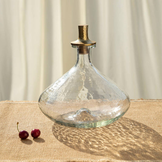 the collective pebbled glass wide decanter // Handcrafted pebbled glass decanters feature punt bases and tall, hammered aluminum stoppers in an antiqued brass finish. These food-safe glass vessels make attractive additions to any bar cart or dining area, whether full of favorite beverages or simply standing empty. Ethically made in India.
