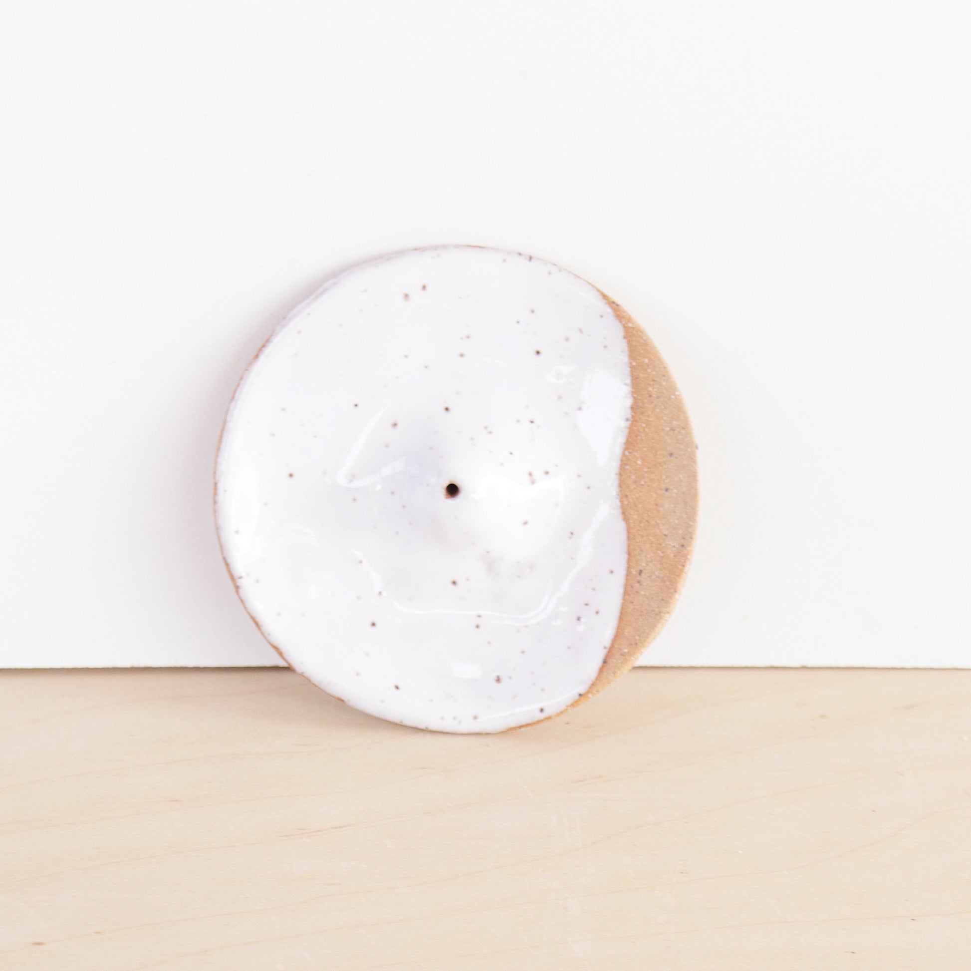 Modern, minimalist incense holder. Made of a speckled stoneware clay, finished with white or lavender glaze. 