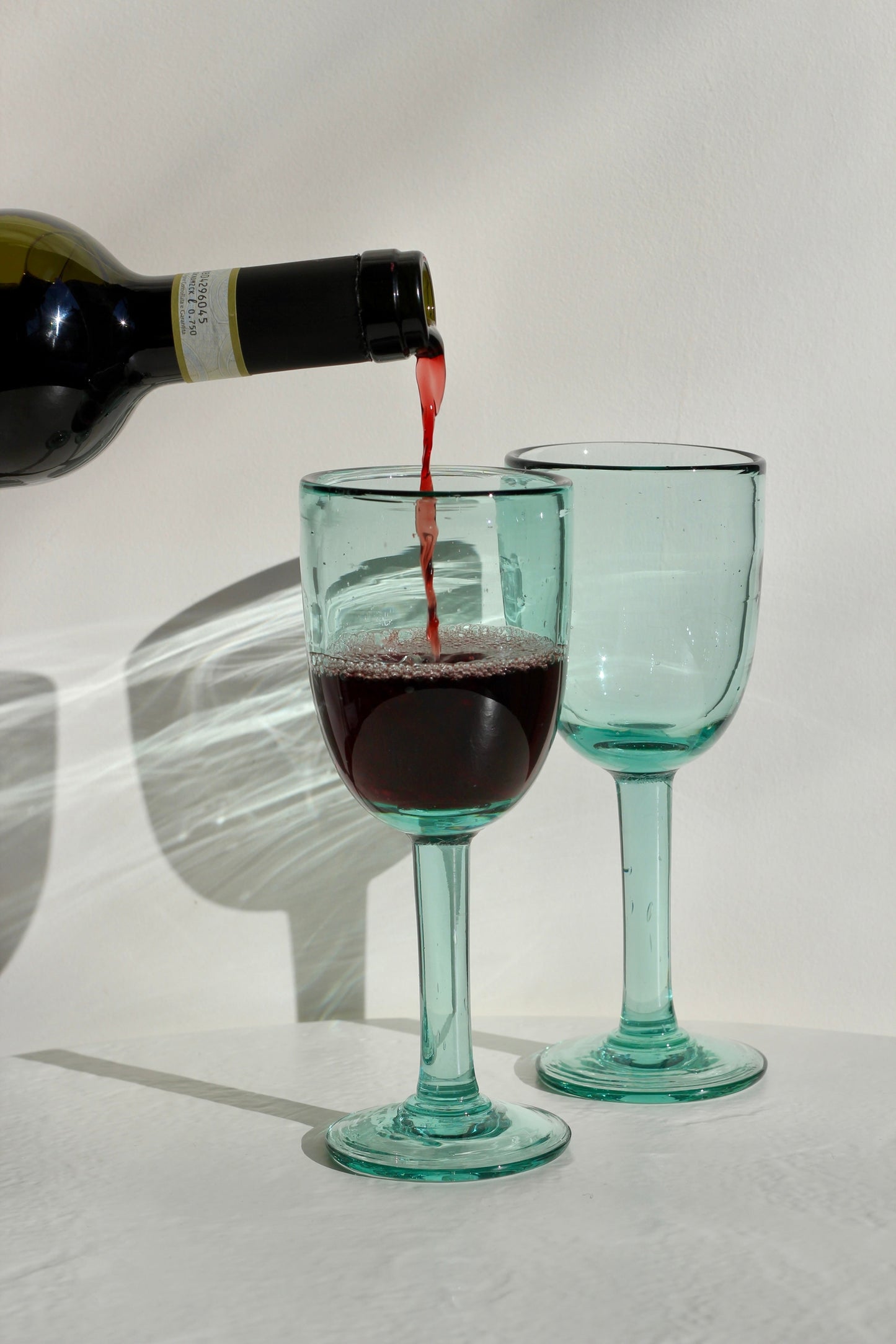 A funky, one-of-a-kind wine glass designed to bring character to any table. With its distinctive handmade feel, this stemmed glass adds a fun touch to serving wine. Each piece is handblown with recycled glass by artisan partners in Bogotá, Colombia.