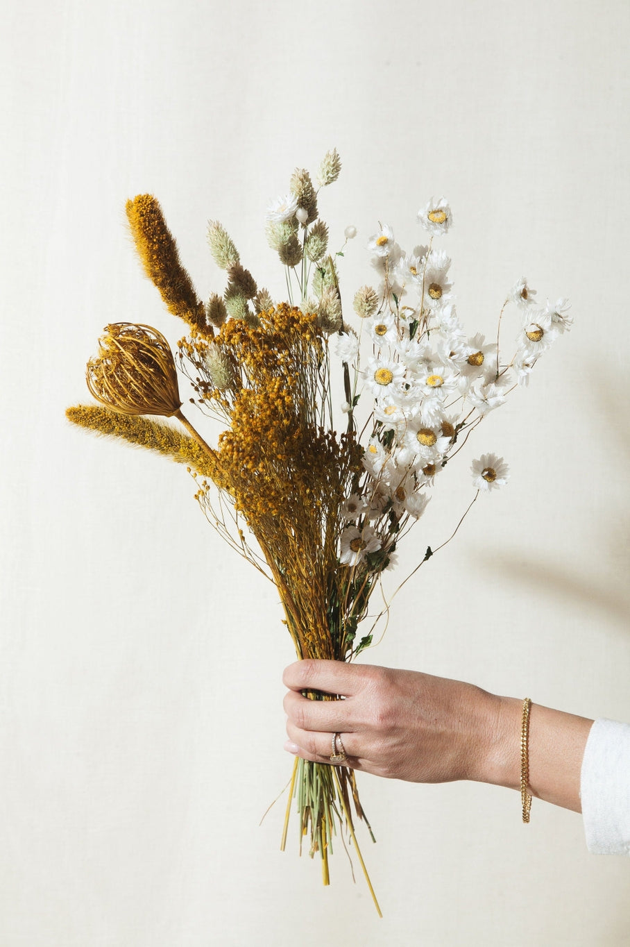 This dried bouquet is carefully arranged by a team of designers in Idlewild Floral Co's California studio, and are made of beautifully preserved long lasting flowers. Perfect paired with a bud vase or as a gift for any occasion. Each bouquet is 22-24" tall and 11-12" wide wrapped.