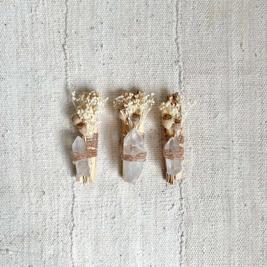 high summer palo santo bundle / Two ethically sourced palo santo sticks wrapped up with bleached broom bloom, poppy pods, and a clear quartz crystal using vintage string. catherine rising
