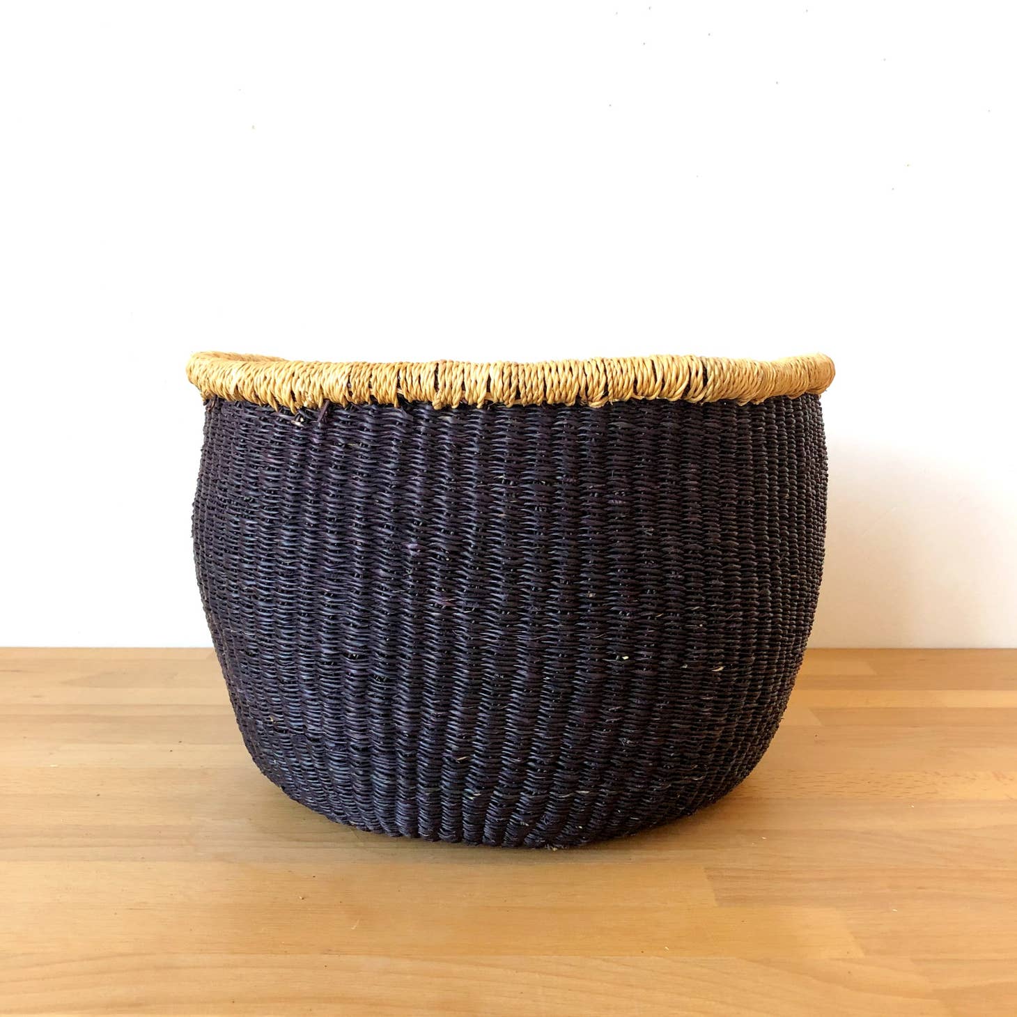 This storage basket is great for holding blankets, toys, knitting supplies and other things.  It is handwoven from veta vera grass in northern Ghana. The grass is dried, split, rolled, and dyed, before being woven into this beautiful work of art.
