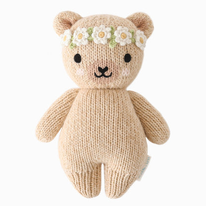 Knitted teddy bear with a flower headband on a white background.
Absolutely adorable and oh so collectible! At an endearing 7” tall, our lovingly hand-knit baby animals are made with natural 100% cotton yarn and perfectly sized for little hands to grab and hold.

Every baby animal purchased provides 5 meals to children in need and empowers artisans in Peru and Nepal with fair trade income.