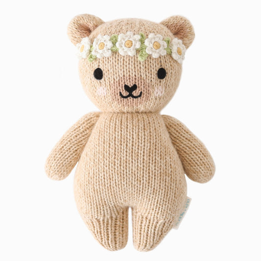 Knitted teddy bear with a flower headband on a white background.
Absolutely adorable and oh so collectible! At an endearing 7” tall, our lovingly hand-knit baby animals are made with natural 100% cotton yarn and perfectly sized for little hands to grab and hold.

Every baby animal purchased provides 5 meals to children in need and empowers artisans in Peru and Nepal with fair trade income.