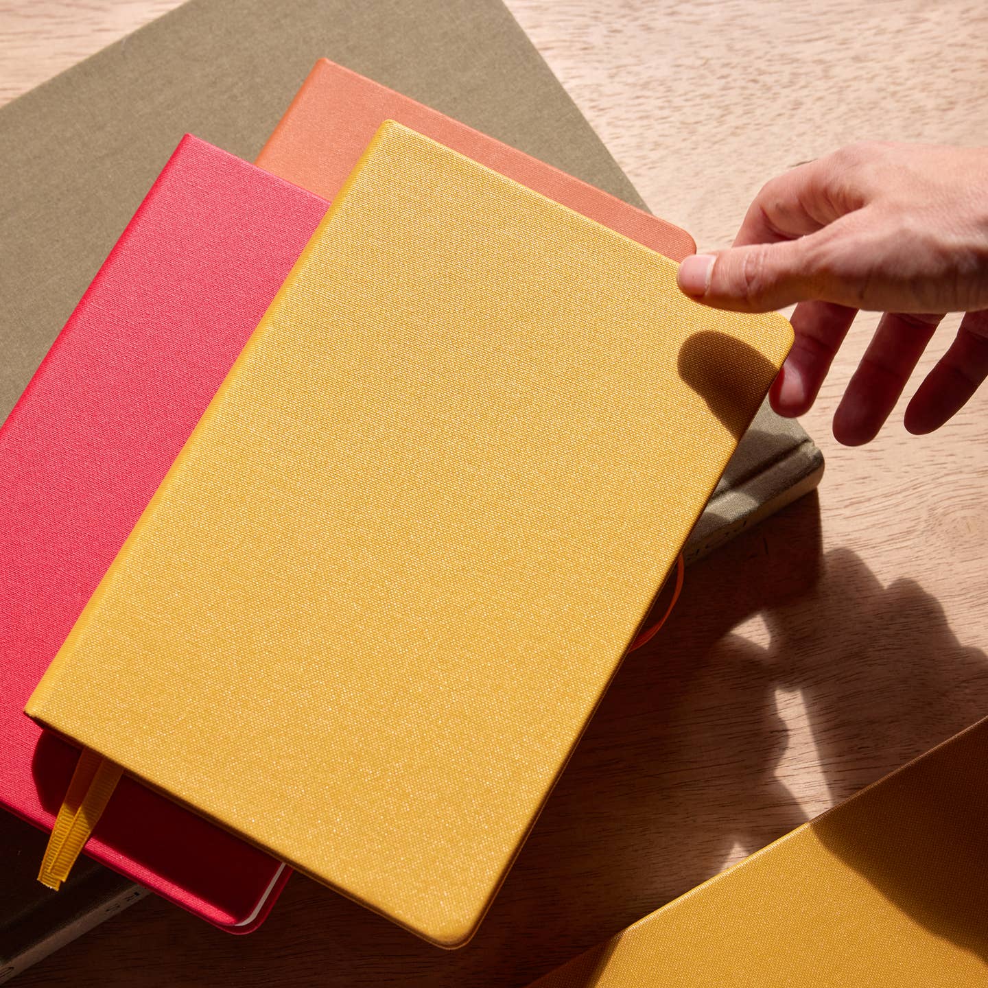 Bright hardcover journals are easy gifts under $25 for anyone creative.