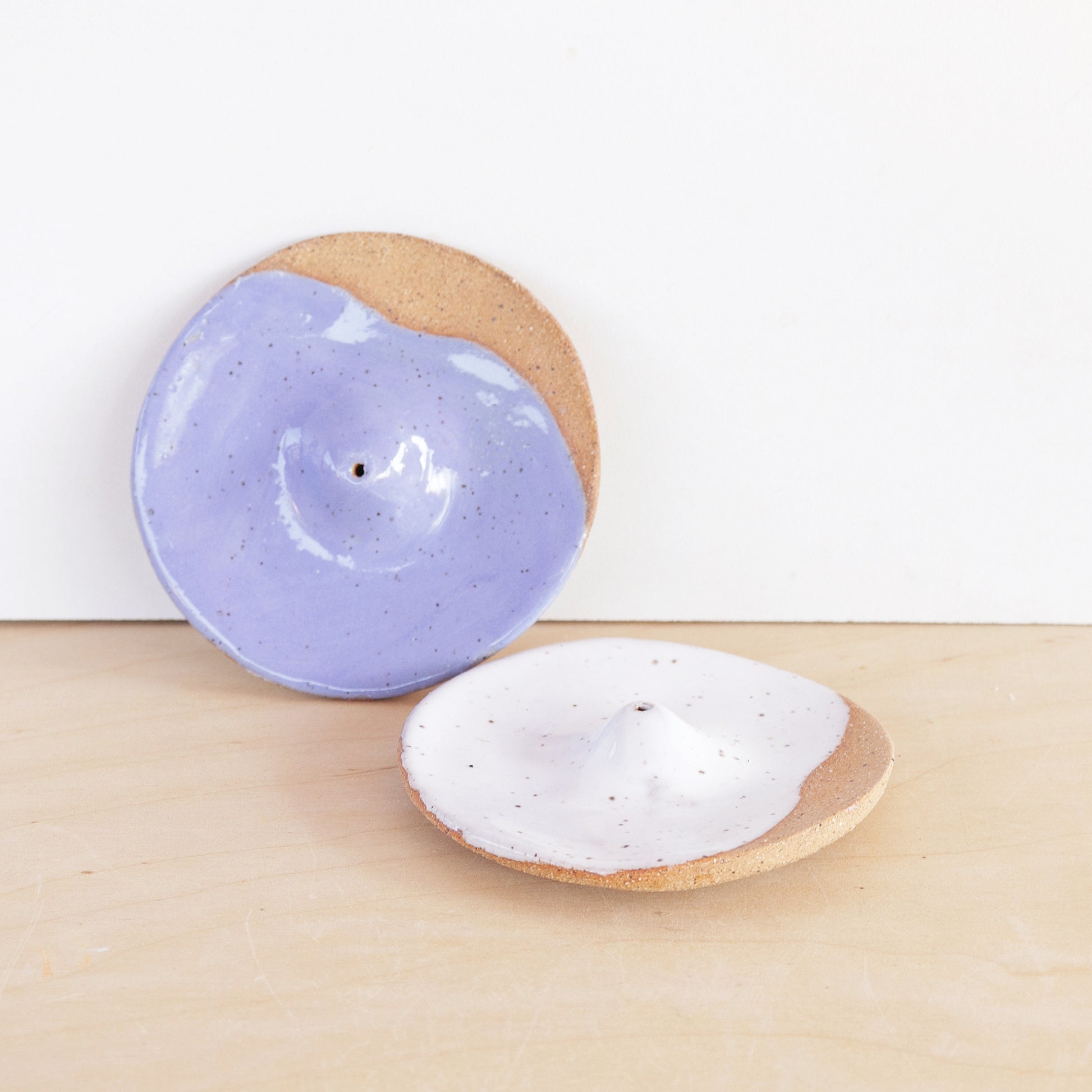 Modern, minimalist incense holder. Made of a speckled stoneware clay, finished with white or lavender glaze. 
