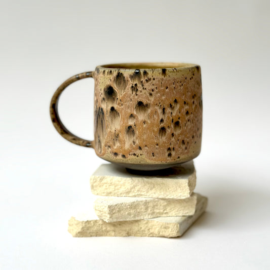 Step back in time with The Era Mug. Inspired by the eclectic and earthy ceramic style of the 1970s, each piece is carefully hand-painted, making every mug unique with subtle variations. The glaze is painted atop a rich, custom brown clay that is exclusive to Pigeon Toe Ceramics.