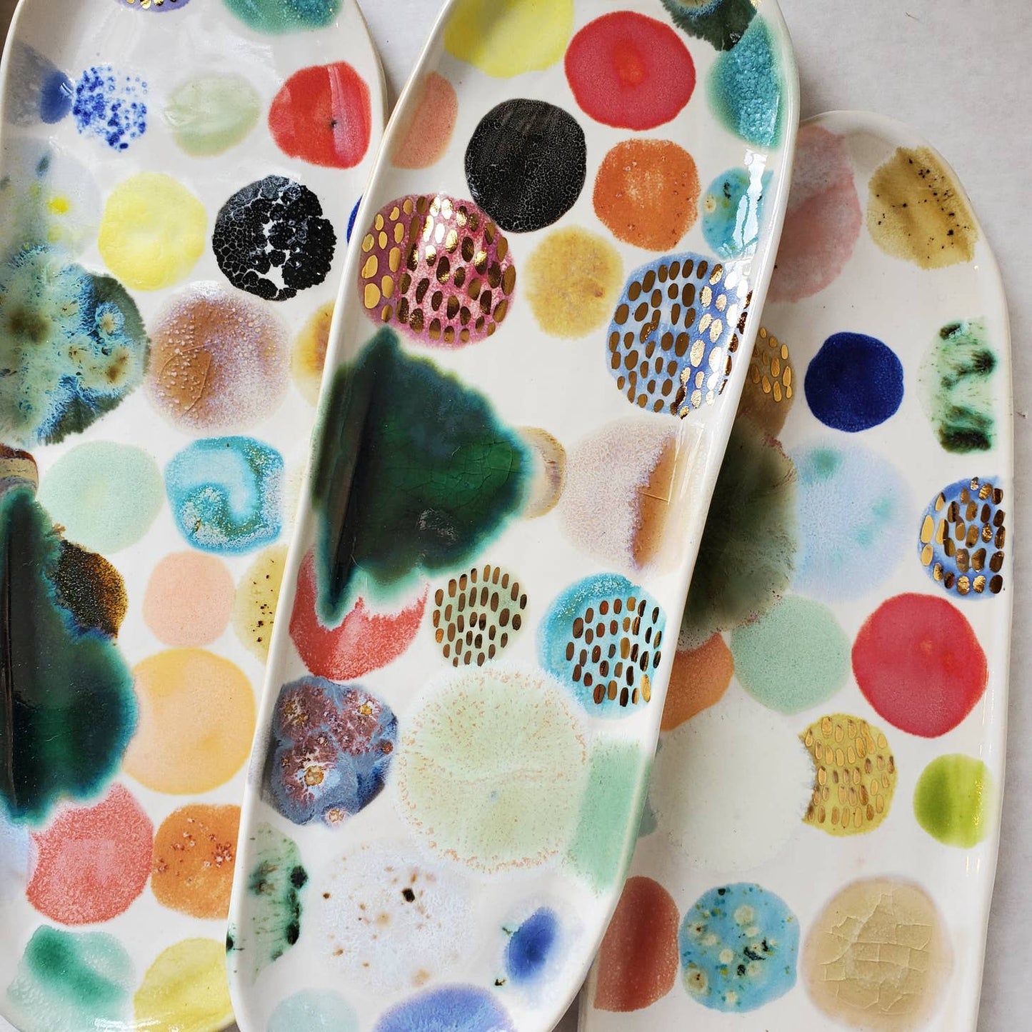 ceramic curious clay / Handmade snack tray featuring colored splotches and gold luster to turn any cocktail or dinner party up a notch. Each tray features one-of-a-kind glaze applications and is completely unique. The perfect host or hostess gift!