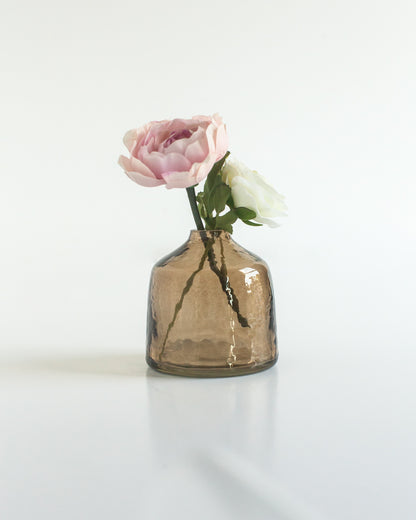 bella hammered glass bud vase . Ideal for showcasing a single bloom or a small bouquet, these bud vases bring a touch of subtle texture to any space while honoring a commitment to people and the planet.