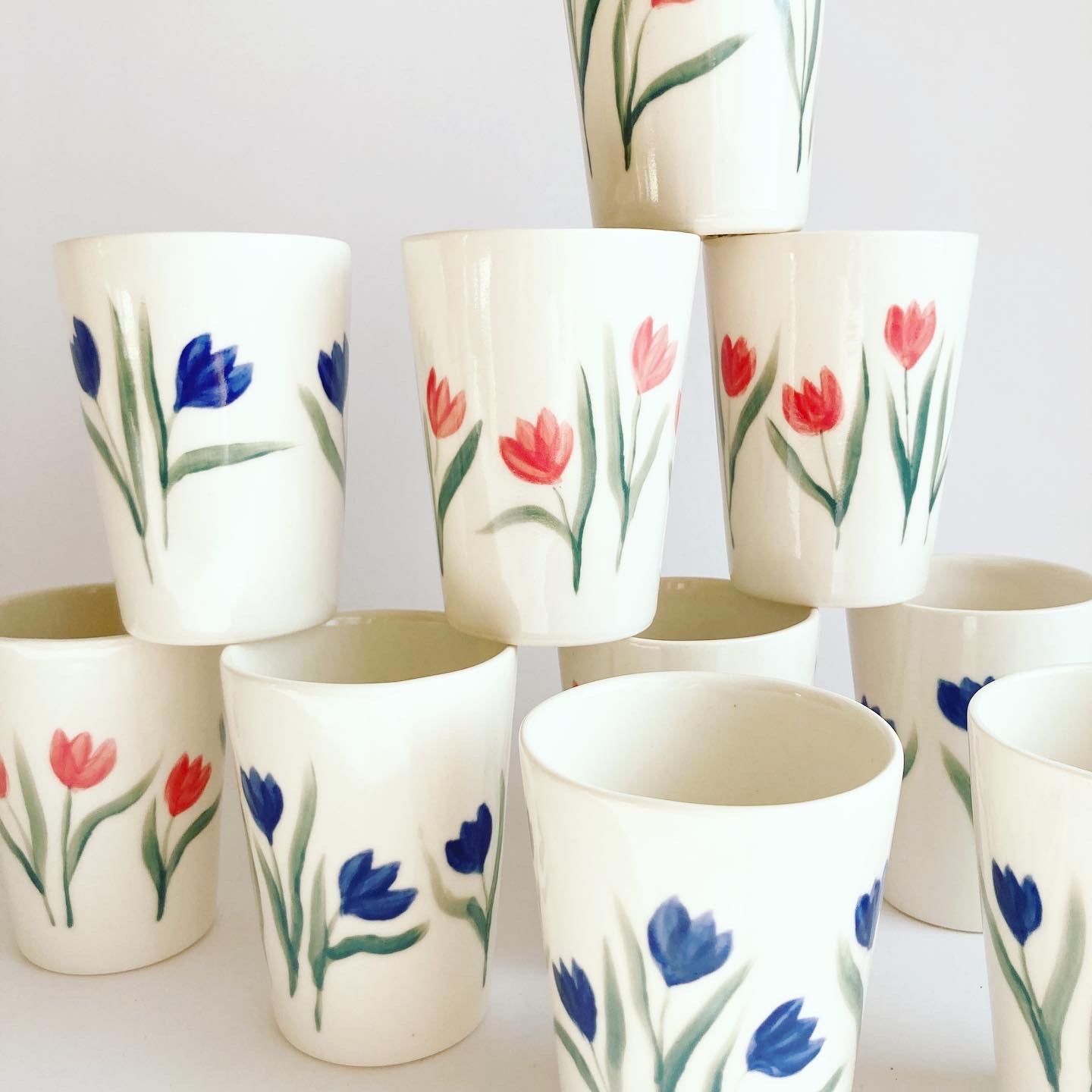 tulips ceramic cup / Slip casted ceramic cups in dover white (off white) and painted with blue tulips. Handmade by Alicja in her Vermont studio.