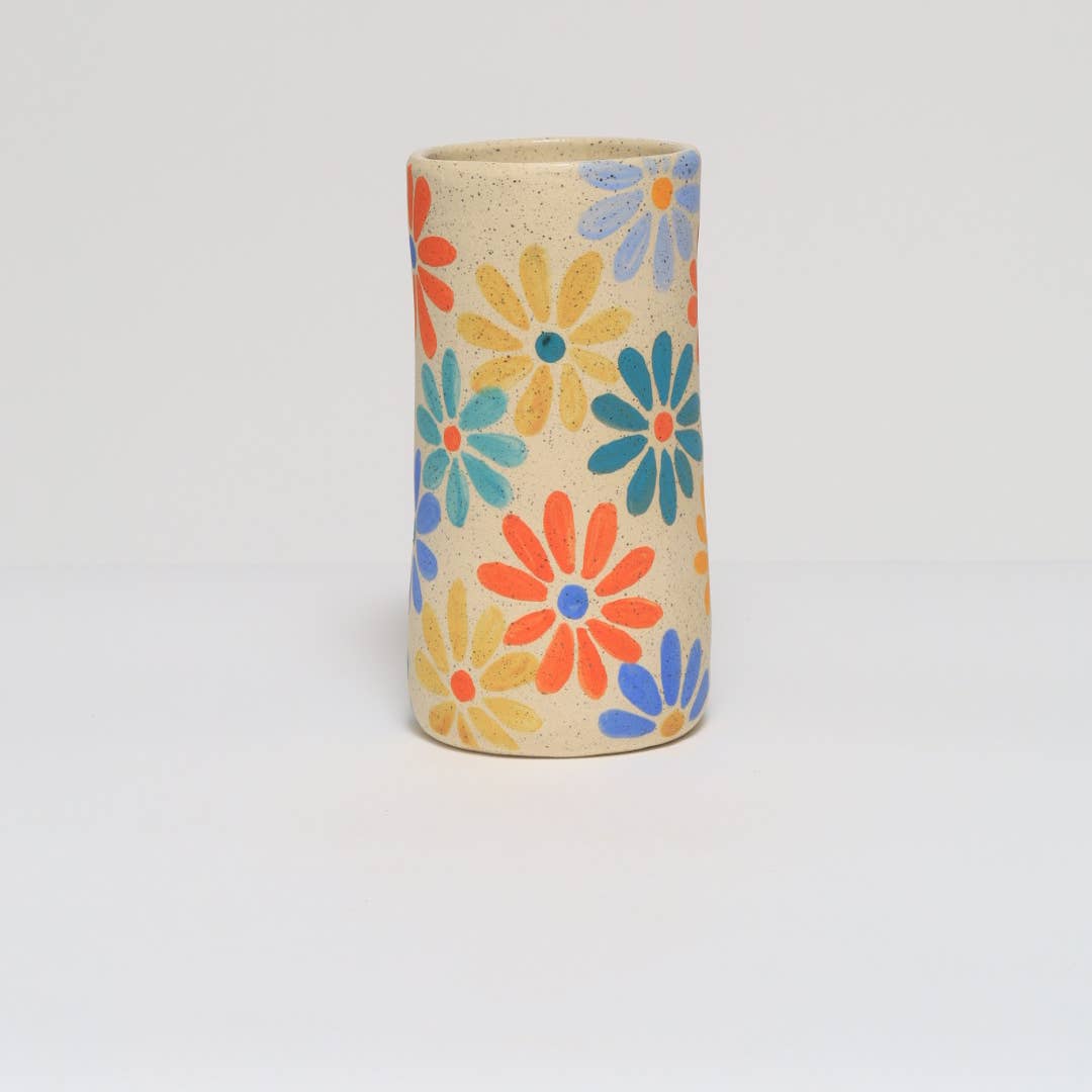 Handmade ceramic vase featuring a colorful hand painted flower design.
