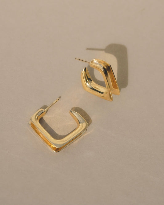 Convex, organic and simple geometric hoop earrings.