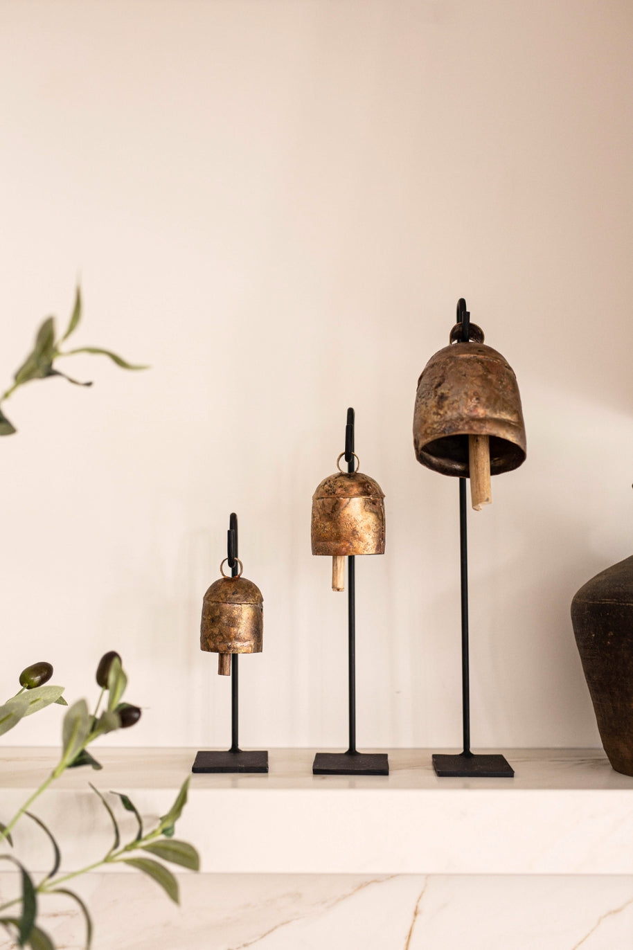 This set of 3 bell stands are crafted from iron and feature welded hooks, creating an artistic and unique display. These copper bells can make a dramatic, decorative statement in any living space.