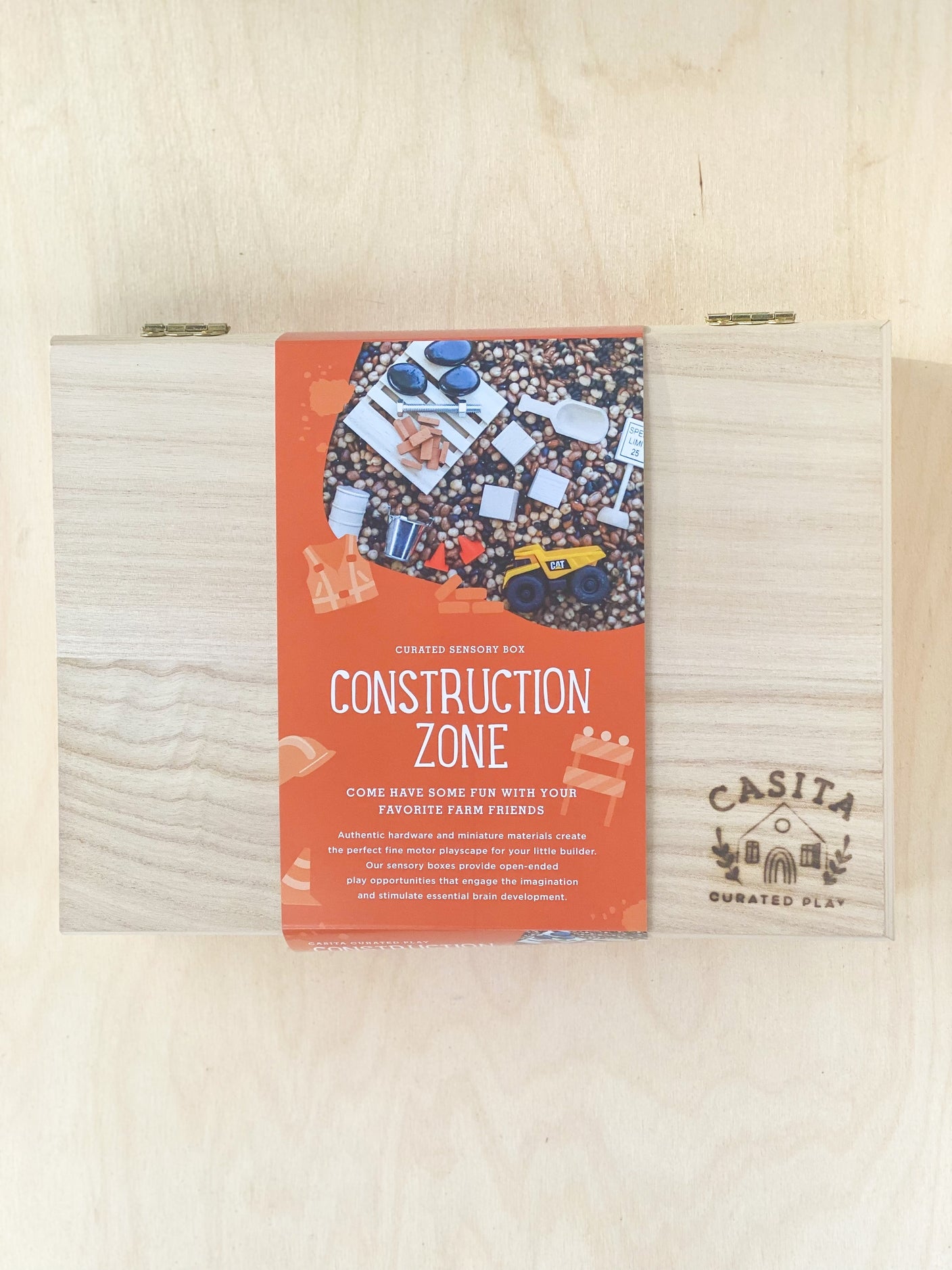 casita curated play / The Construction Zone Sensory Kit is packed with all the building materials to construct the scene of your dreams! Includes one vehicle, large wooden pallet, miniature clay bricks, wooden blocks, wooden sign, wooden barrel, cones, & metal pail. An authentic nut & bolt are provided for the ultimate fine motor practice! 