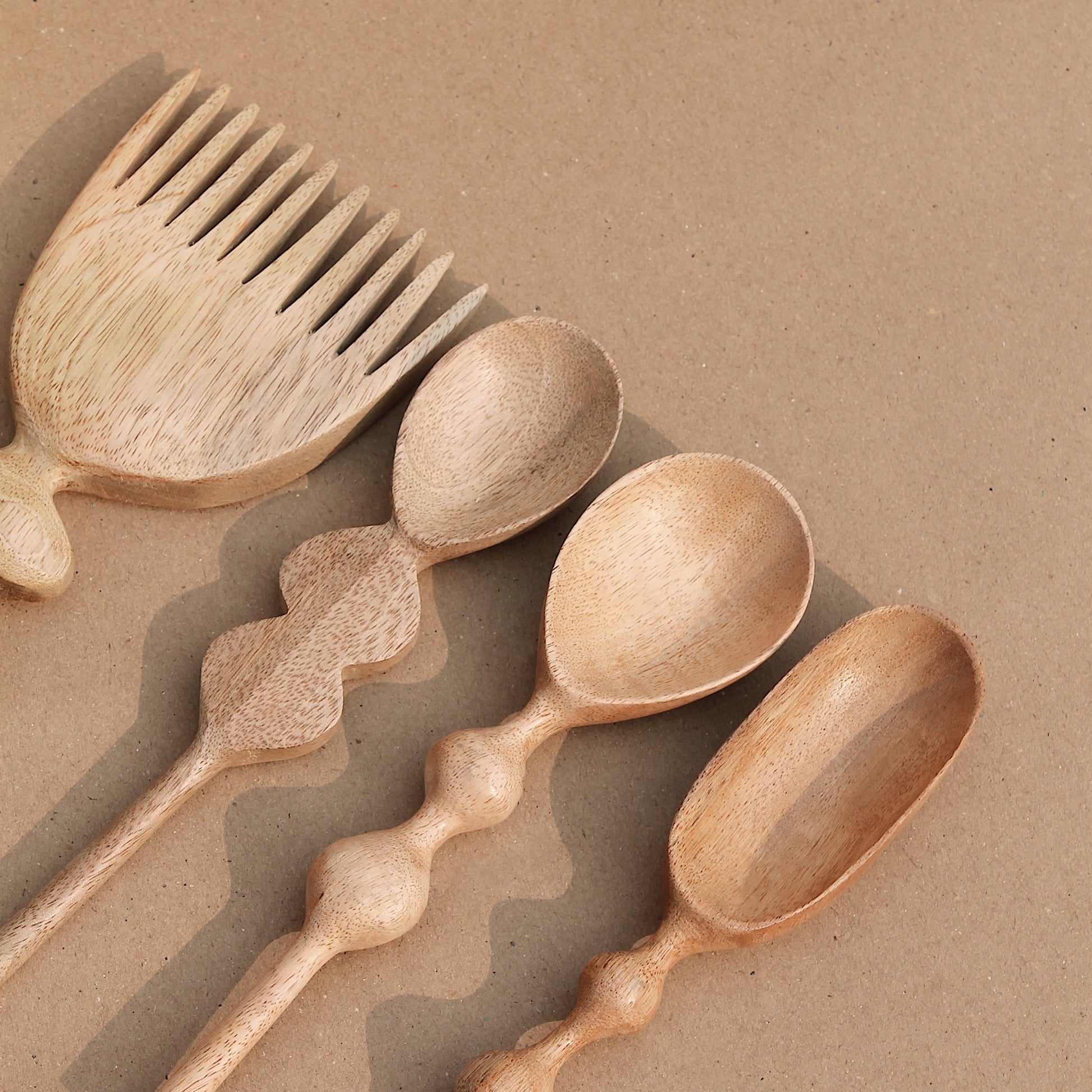 Discover the joy of cooking with these handcrafted wooden spoons! Artisans have infused each piece with love and creativity, featuring groovy handles for a fun and easy grip. Handmade in India.