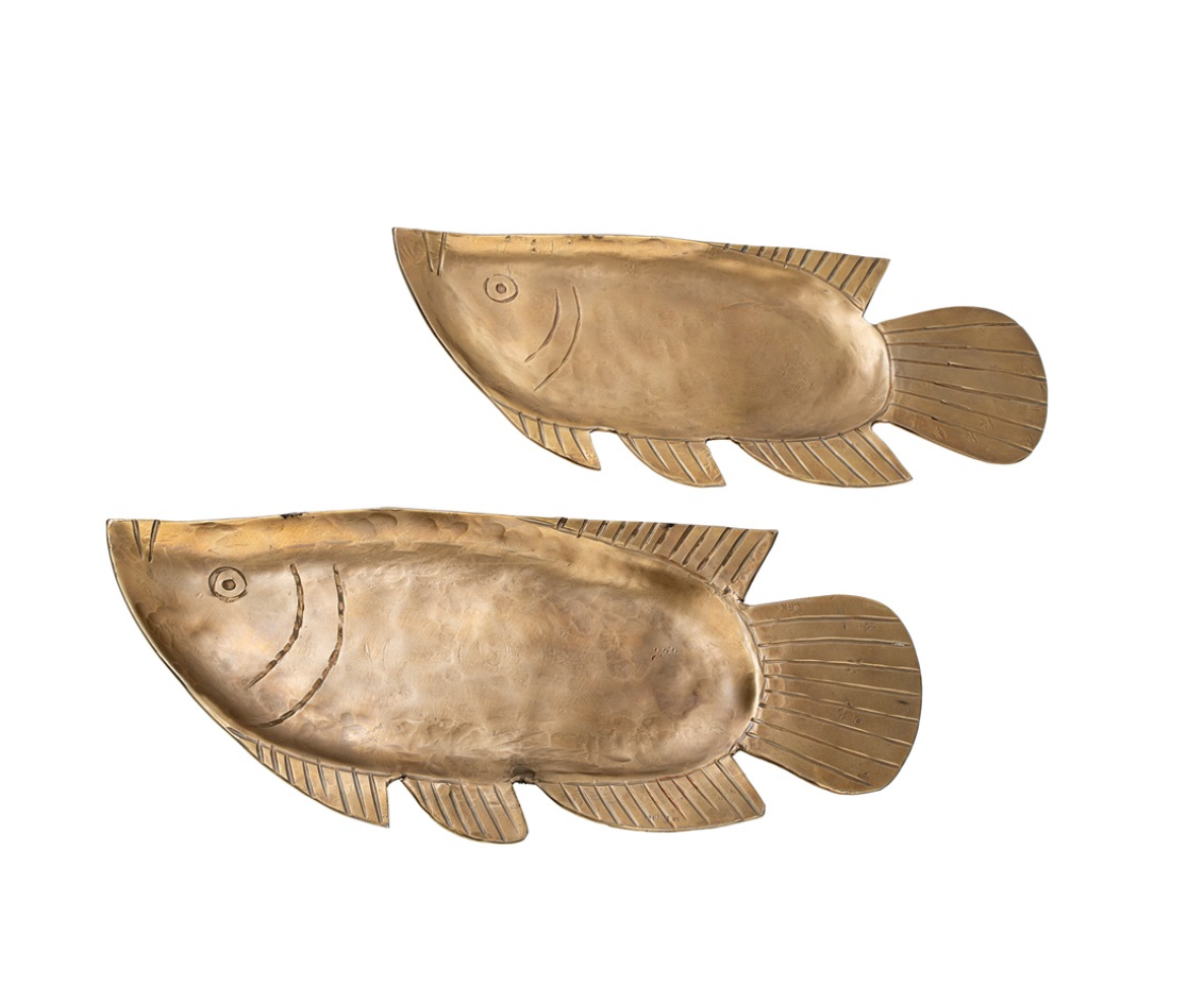 Two gold fish-shaped decorative items on a white background