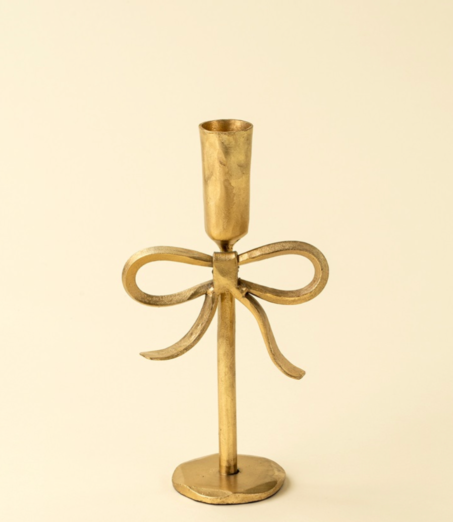 Gold bow candlestick hand forged ethically in India.