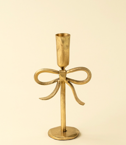 Gold bow candlestick hand forged ethically in India.