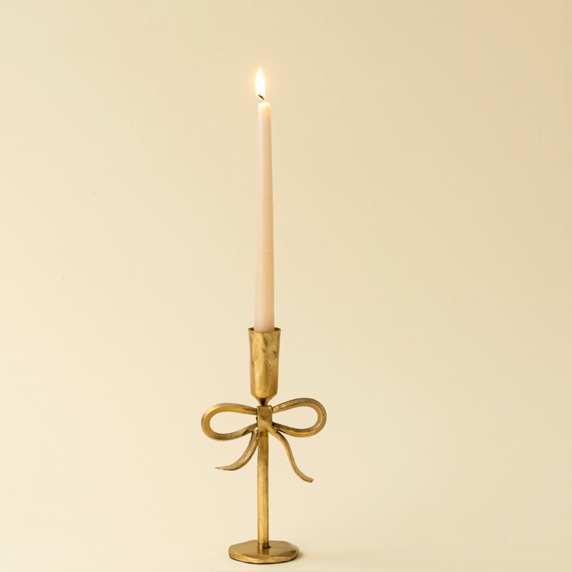 Gold bow candlestick hand forged ethically in India.