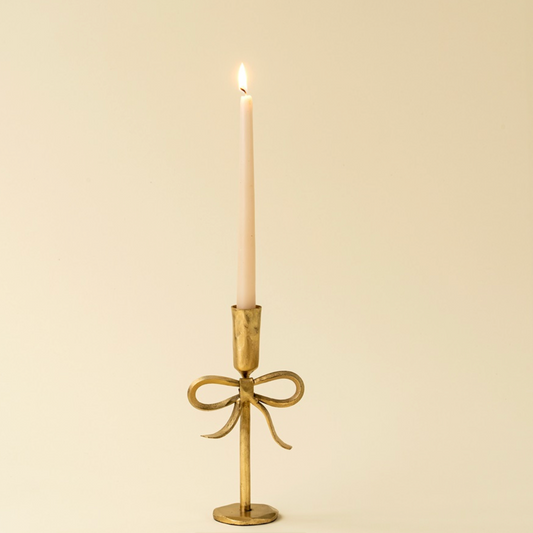 Gold bow candlestick hand forged ethically in India.