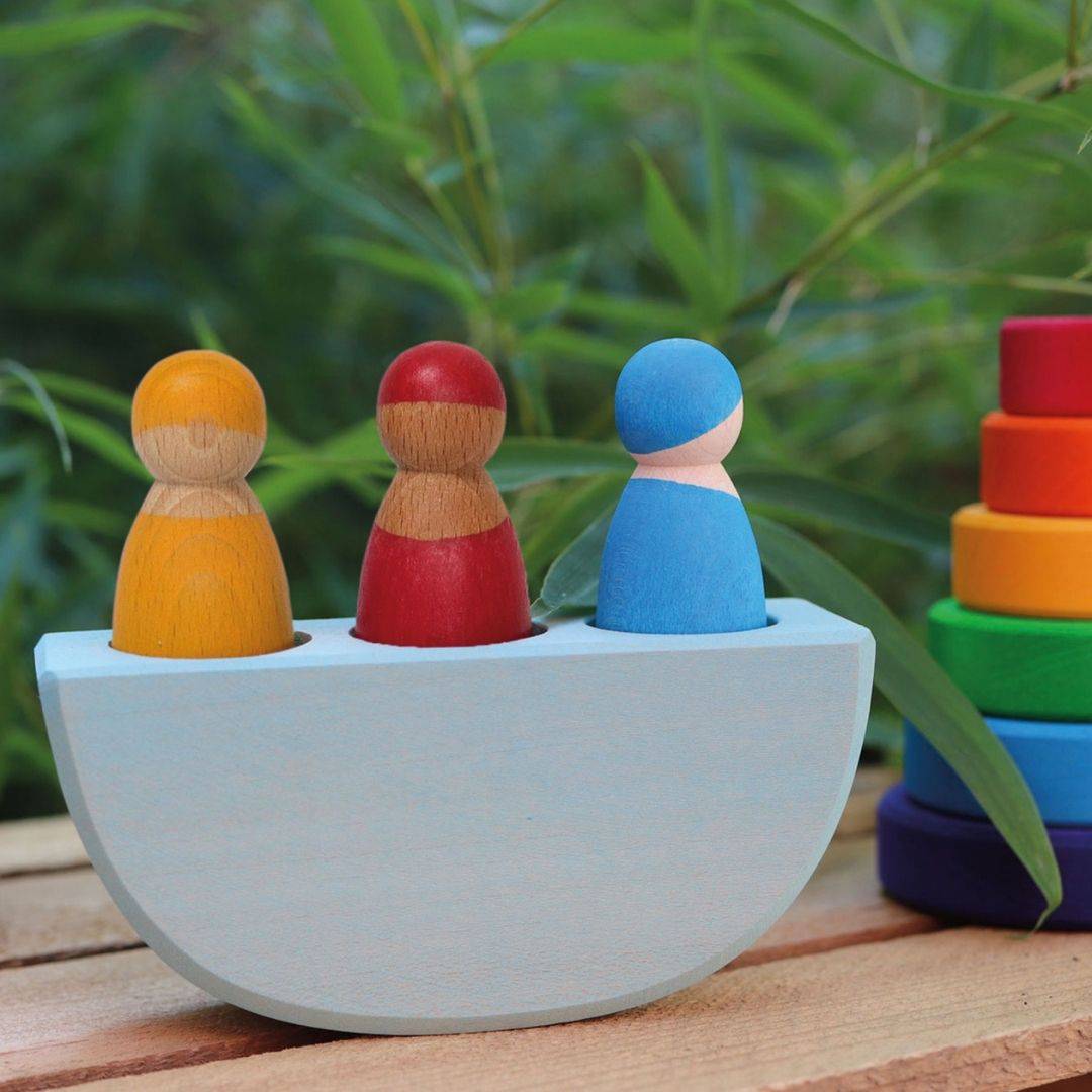 Wooden toy boat with three peg dolls by Grimms.
