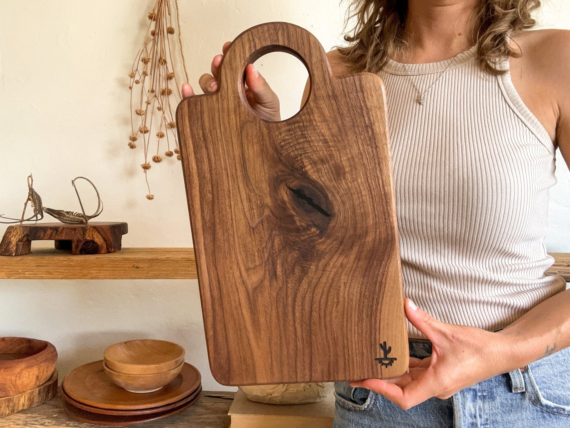 A modern design featuring a circular handle. These are made out of either hard maple that is know for its neutral grain and durable surface or dark walnut that is know for its moody grain with stripes of caramel. Great boards to grab for a quick chop or made as your designated home bar board for citrus.