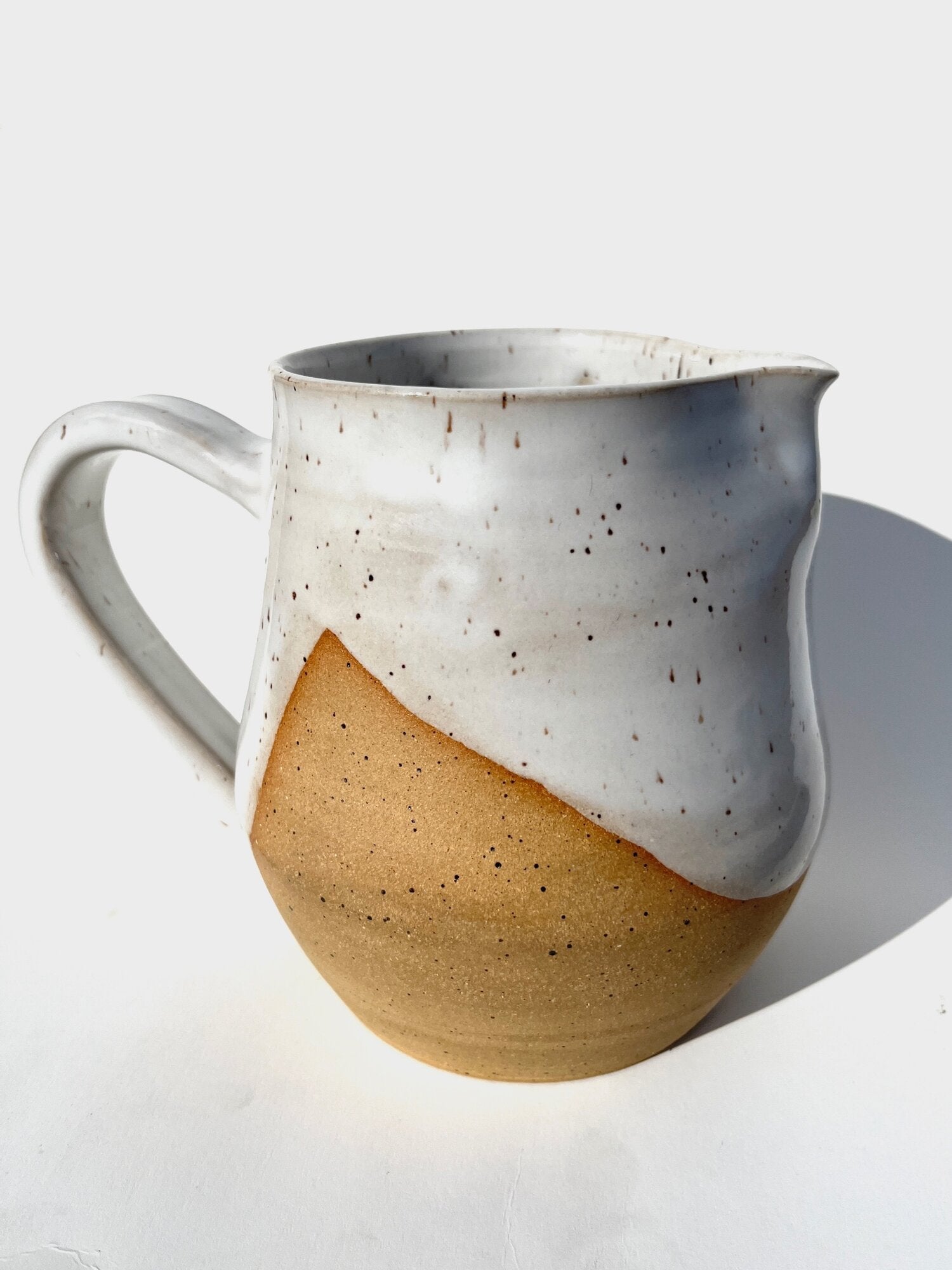 Inspired by the snowfall on the dry landscapes of western Colorado. This pitcher is perfect for 4 mugs of coffee, tea, lemonade, or sangria! When you're not using it for drinks, fill it with some fresh cut flowers.