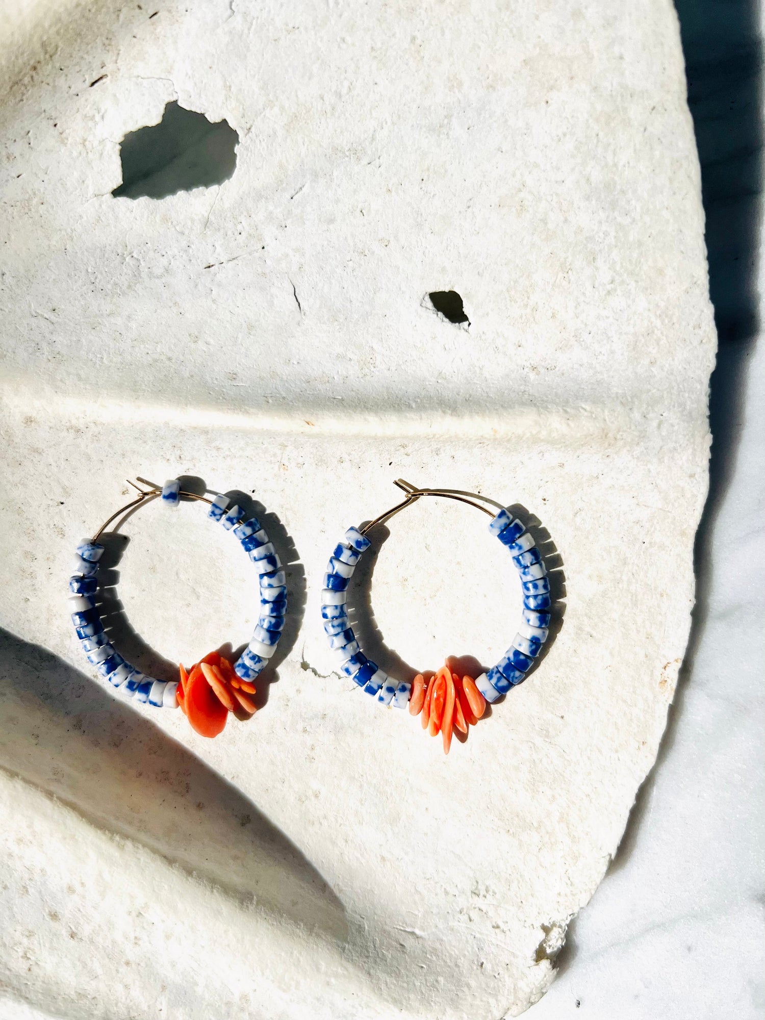 Sodalite and coral shell bunch hoop strung on gold fill hoops. Designed in California by Carrie Marill and made by hand in her SoCal studio.