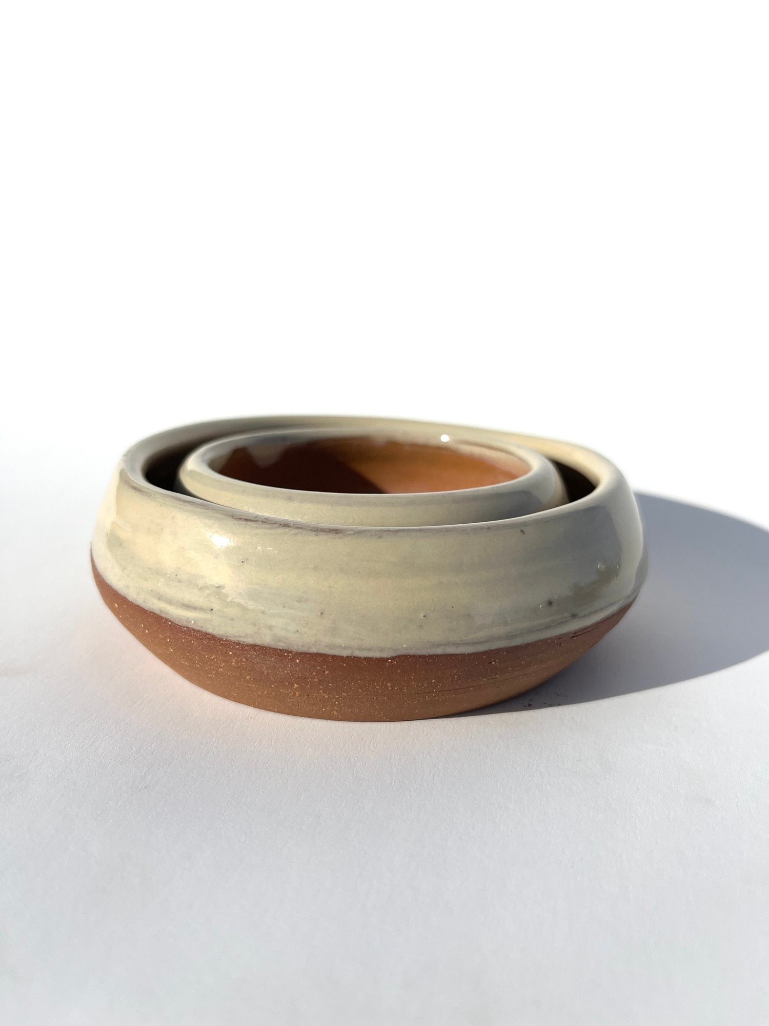 Hand thrown and hand dipped glazed ceramic nesting bowls by Ninth House Goods. A pair of nesting bowls that would be perfect for oil dipping, salsa, or your special jewels and artifacts.