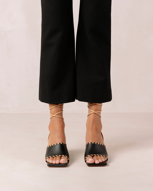 Thanks to their rounded mid heel and thick front strap, these chic lace-up sandals strike a balance between comfort and flair. Crafted from premium black leather, they have long, slim straps which wrap delicately around the ankle for a secure fit. Sustainably made in Spain. Alohas Kitty Black Leather Sandal.