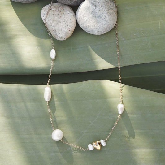 This satellite necklace includes varying sizes of baroque freshwater pearls and a gold accent heart. The perfectly imperfect pearls are connected with a 14k gold fill chain and hand-wrapped wire. All Dea Dia pieces are designed and handmade in Downtown Los Angeles.