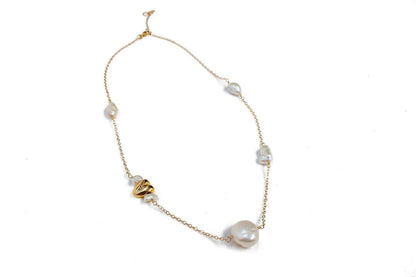 This satellite necklace includes varying sizes of baroque freshwater pearls and a gold accent heart. The perfectly imperfect pearls are connected with a 14k gold fill chain and hand-wrapped wire. All Dea Dia pieces are designed and handmade in Downtown Los Angeles.