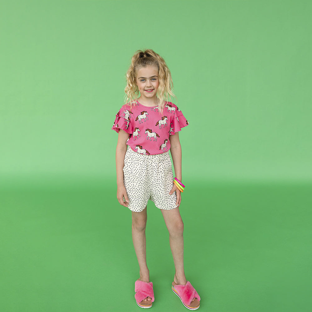 Light weight shorts with a longer fit. Elasticized waist band with pockets & a mini polka dot print.  Ethically produced, colorful and fun with an eye towards comfort, style and joy. Modern and sustainable kids clothing by CarlijnQ of the Netherlands.