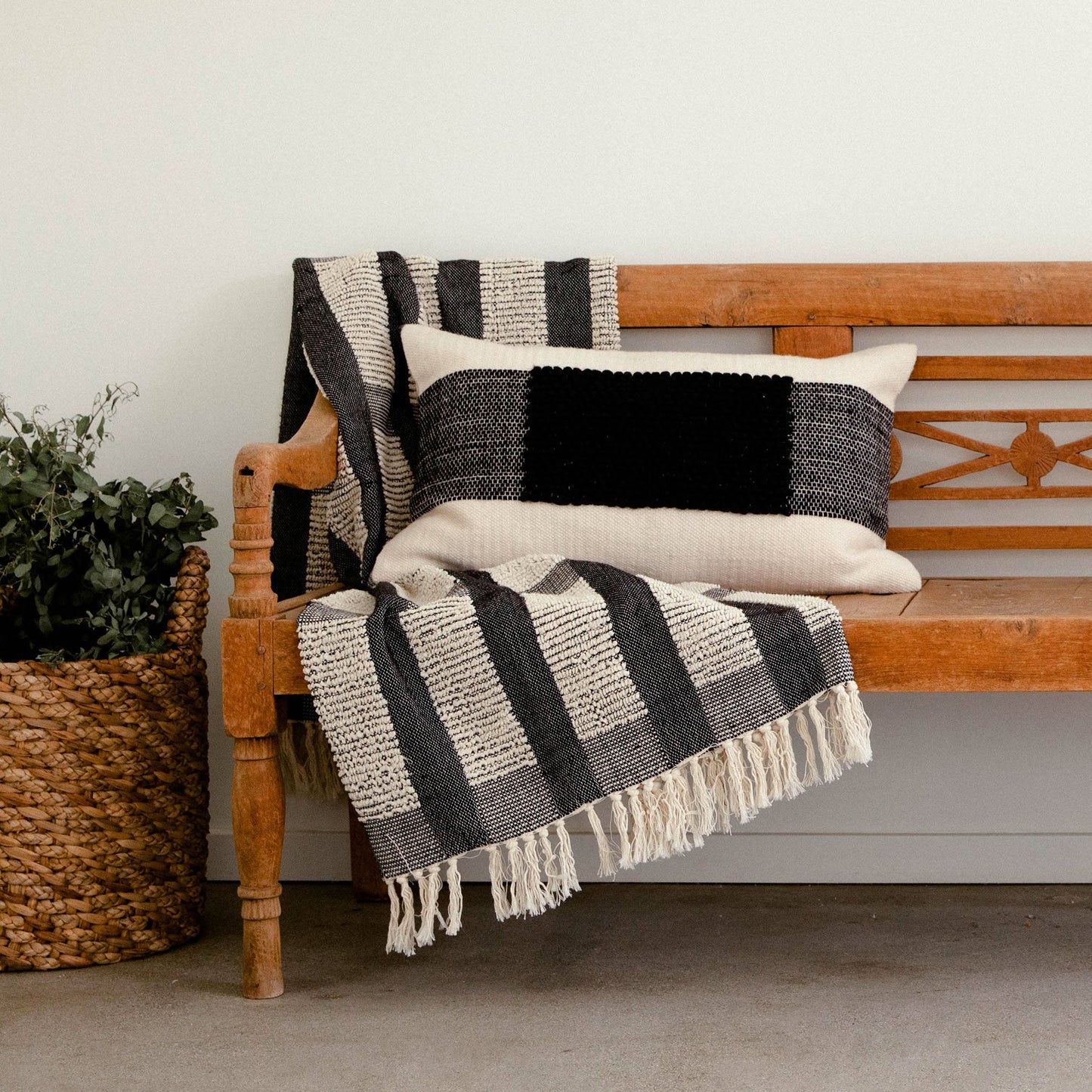 The Cruz Pillow features a natural colored flat weave mixed with a wide contrast stripe of black textured loops. Ethically produced and hand woven by talented artisans in India.