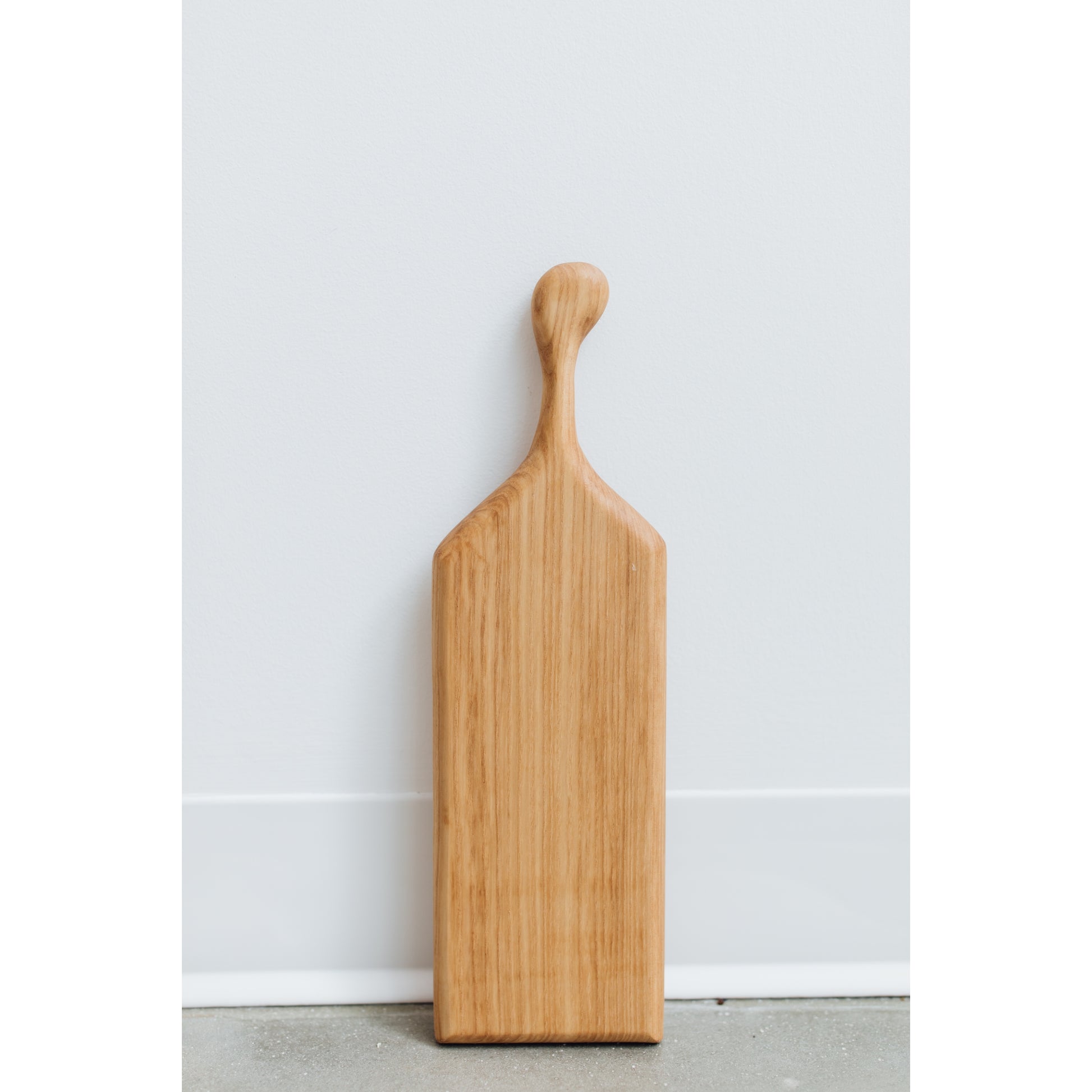 Hand-crafted cheeseboard perfect for a small sampling of cheese or appetizers. The handle is perfect for carrying to the table, and adds visual interest. Made sustainably from maple wood in Gatineau, Canada.
