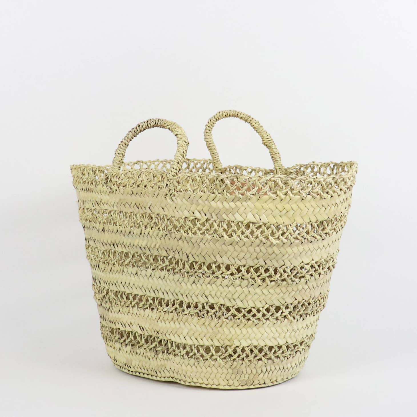 No matter where you sport this bag, you're bound to get compliments. From its gorgeous open weave design to its twisted palm leaf rope handles, the Cannes Basket scores points for being sustainable, ethical, and handmade. Ethically handmade in Morocco.