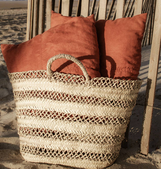 No matter where you sport this bag, you're bound to get compliments. From its gorgeous open weave design to its twisted palm leaf rope handles, the Cannes Basket scores points for being sustainable, ethical, and handmade. Ethically handmade in Morocco.