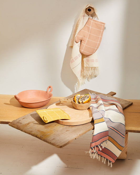 This tea towel is a classic yet modern addition to any kitchen or bathroom. Soft enough to function as hand towels, and durable enough to soak up spills around the kitchen. You can also use them as a centerpiece of a coffee or dining table. Finished with a rustic edge and fringe. Handwoven in Oaxaca, Mexico. 