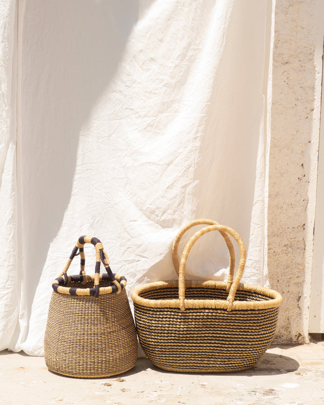 An oval-shaped basket, woven with black & white straw. Perfect choice for a beach day, flower hunting adventure or for storing some of your favorite things. Also big enough to store blankets and toys. available at thread spun.