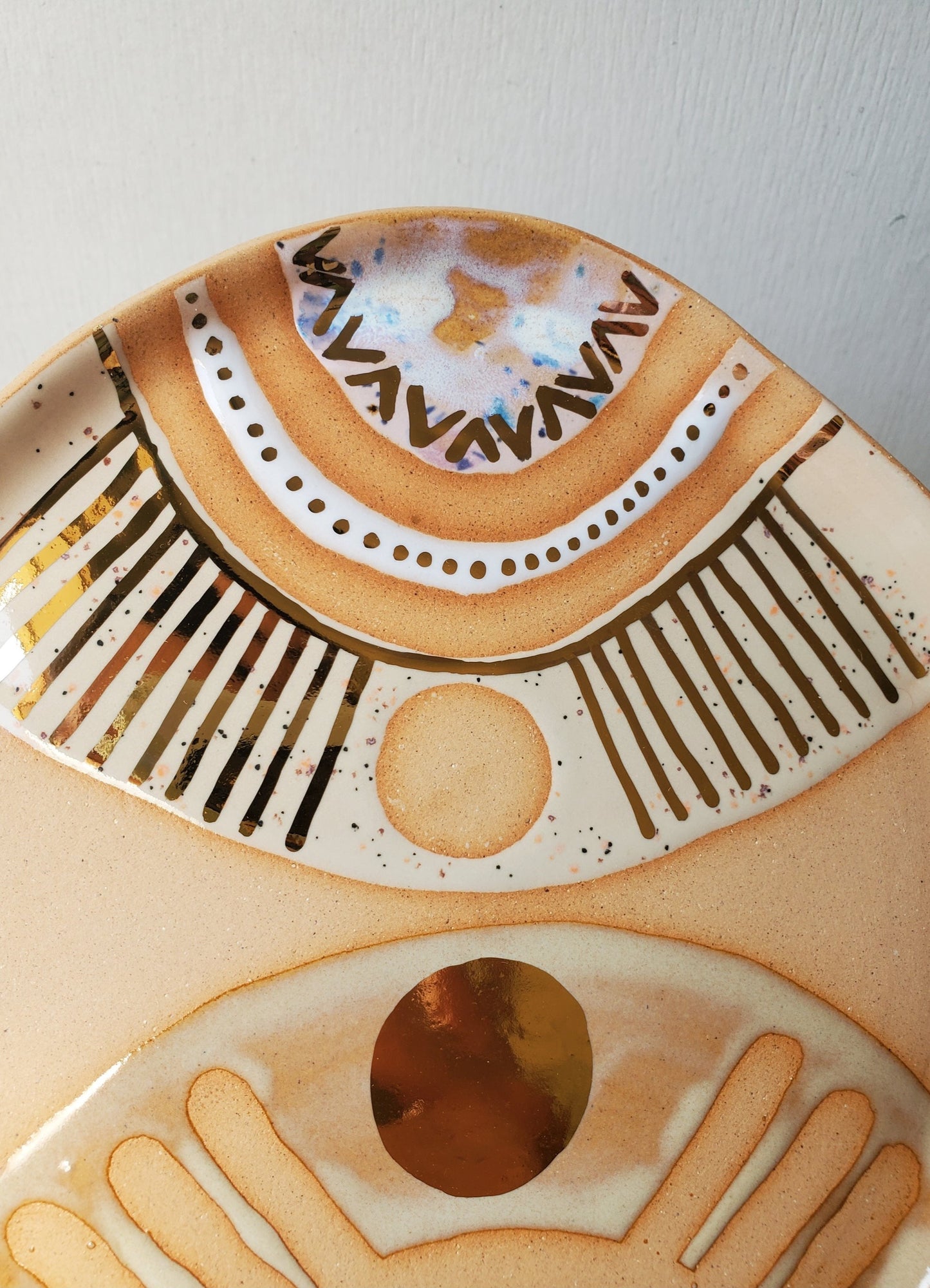 Handmade ceramic dish featuring fun designs and gold luster accents.