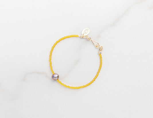 7" 14k gold fill bracelet featuring Japanese glass beads and a pearl, completely one-of-a-kind and handmade by Punkwasp. Made locally in San Diego, California.
