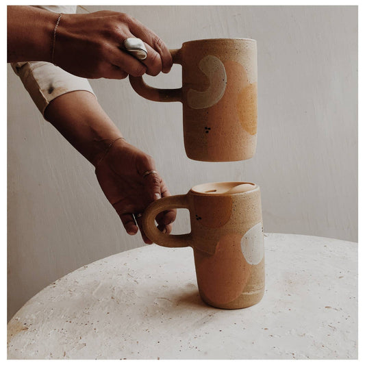 Painted Cup on the go! Includes a PortaVia Universal lid, so when you are tired of this commuter the lid will fit whatever you're feeling that day. Stoneware glazed clear with specks of color. Tapered design and narrow handle allows piece to fit your car cup holder. Handmade in Denver, CO.