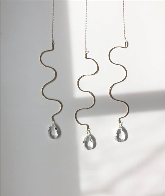 Artisan-crafted sun catcher made from hand forged/hammered brass wire and vintage faceted crystal. Ready to hang by your window where the light pours in and watch the rainbows dance around the room!