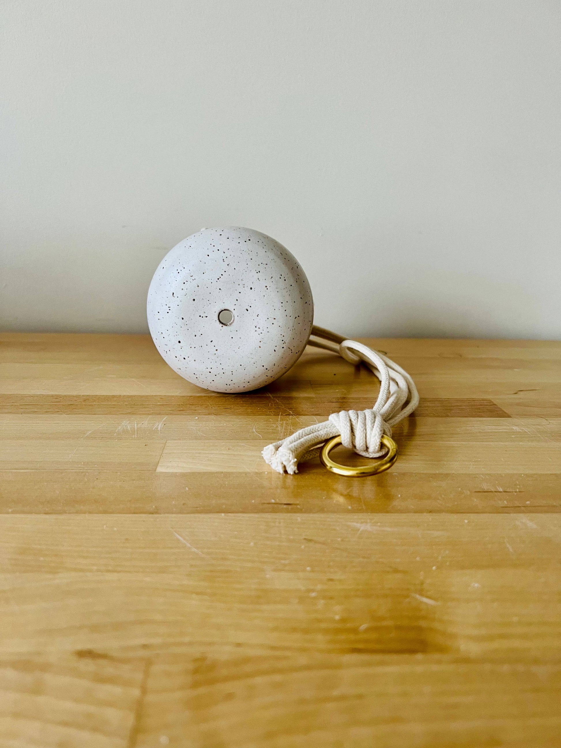 Handmade ceramic planter for your little guys in the home. Earth tone clay with a natural glaze. Includes a drainage hole, cotton cord, and 1" brass ring.