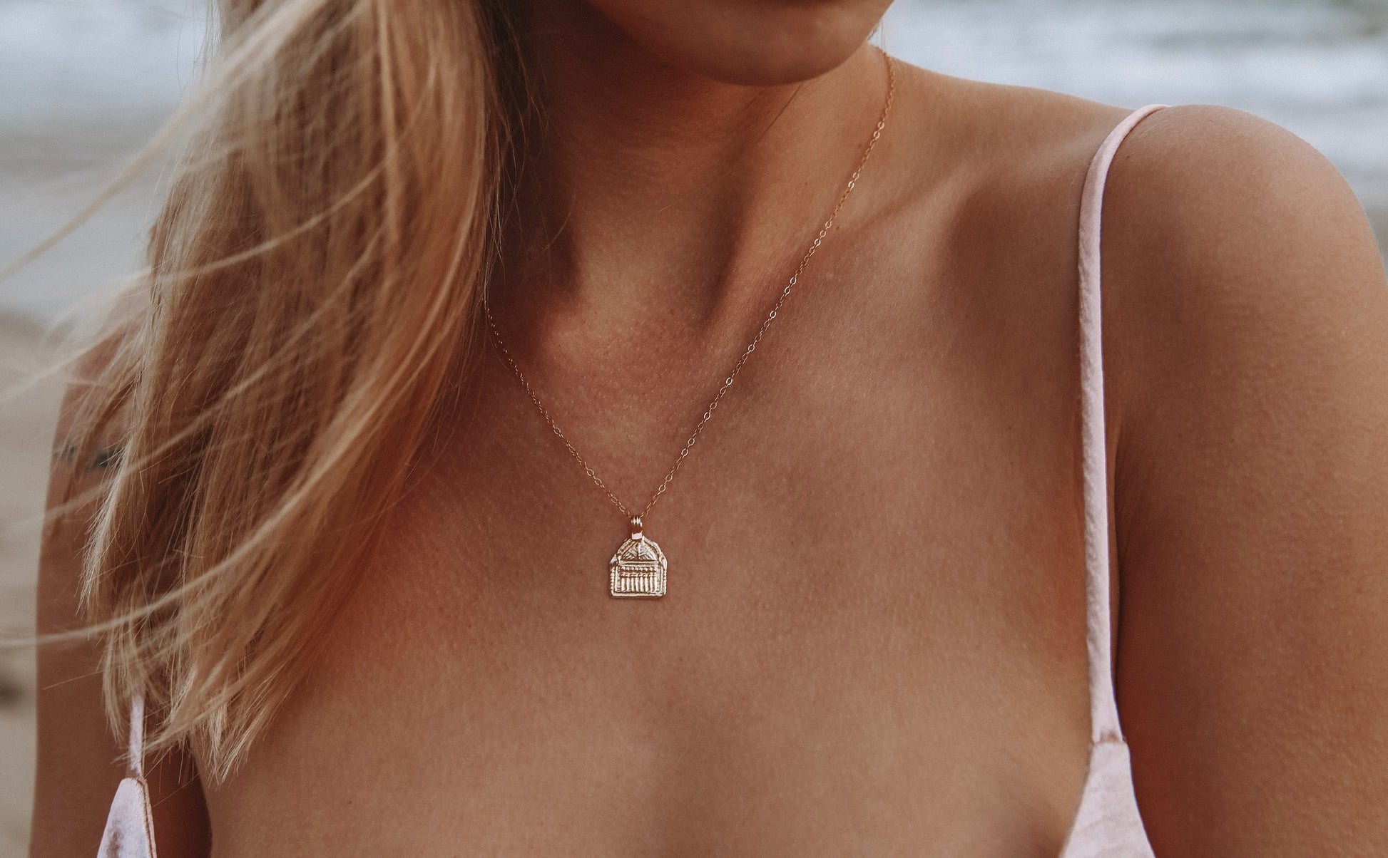 Janus Necklace by Mountainside Jewelry. Delicate light weight hand carved charm necklace designed to represent a door, passageway or opportunity. Recycled brass pendant coated in a thick layer of high grade 14k gold. Handmade in the Santa Cruz Mountains.