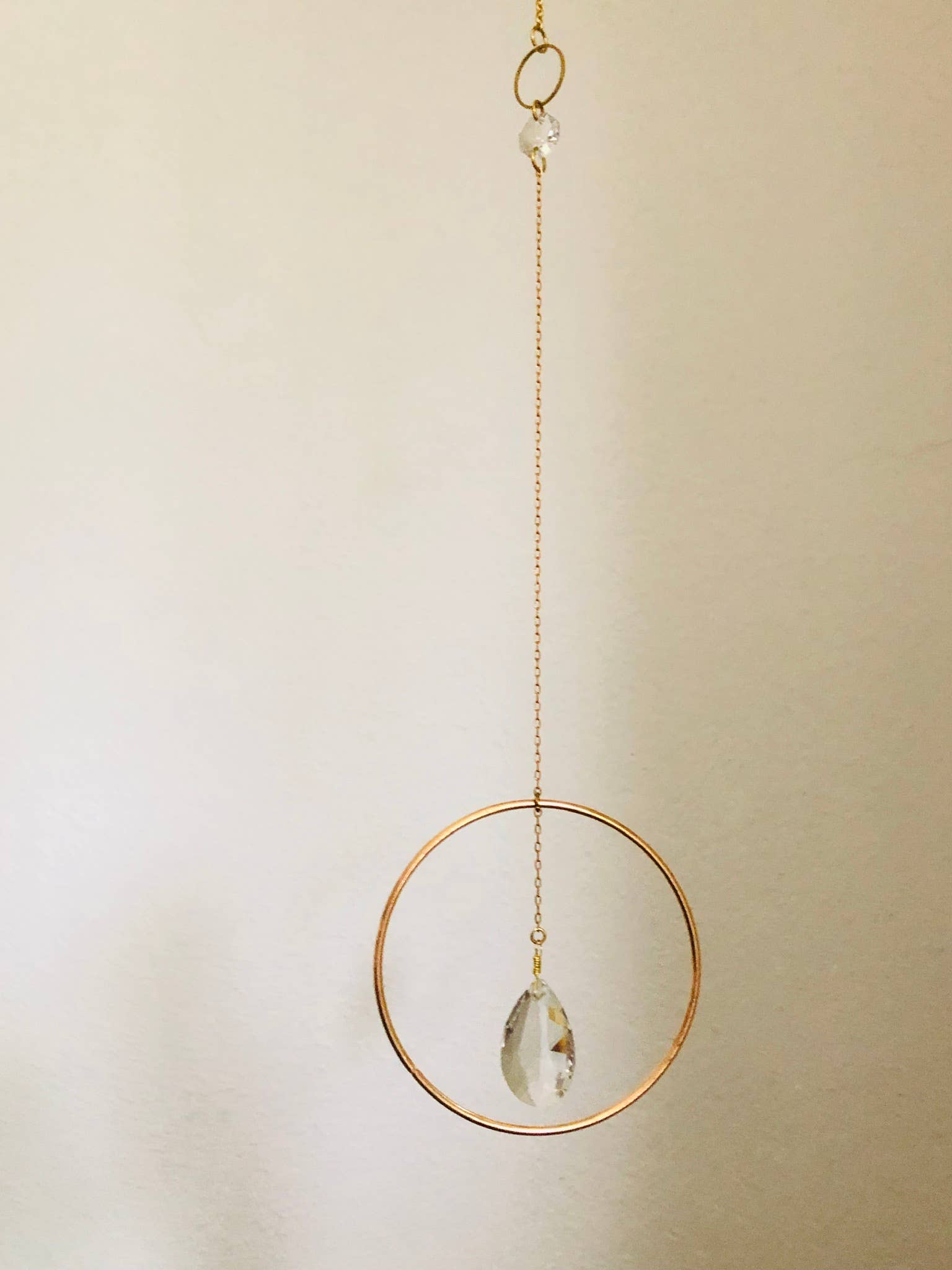 Artisan-crafted light catcher made from brass tubing and 2 vintage faceted crystals. Ready to hang in any space in your home - on a wall to brighten or in a window to catch the light.