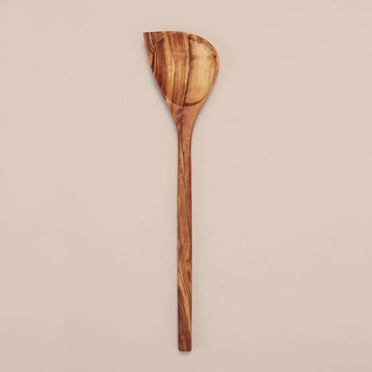 Handcrafted in Tunisia using natural olive wood from the region,  this corner spoon kitchen utensil is hard, durable and non porous. Each piece is unique and becomes even darker, richer and more beautiful in color as it ages.