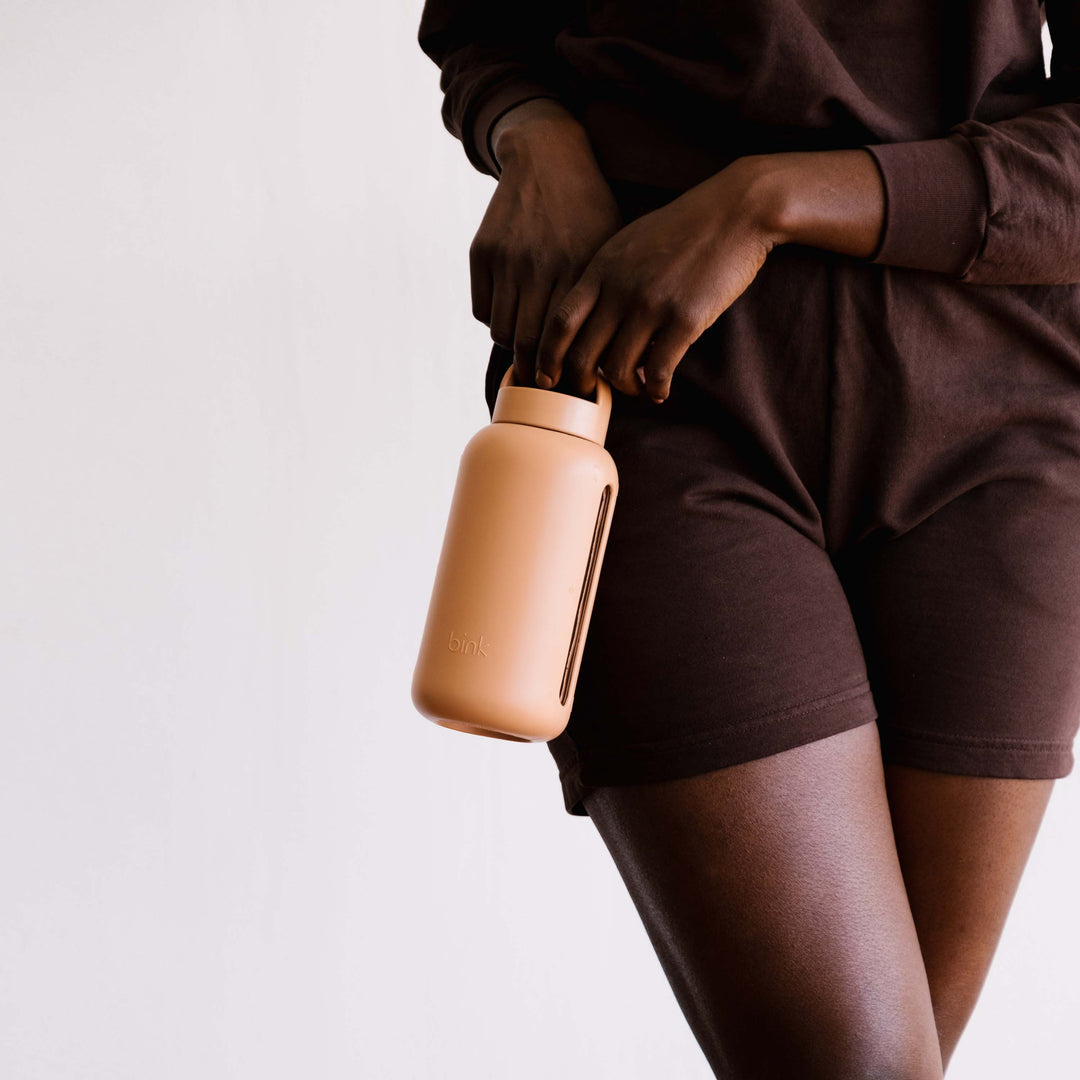 The Day Bottle in Honey, a simple glass bottle with hydration tracking empowers you to be more mindful of the water you drink every day. Simple to follow AM/PM time markings on the bottle sleeve help you drink all day. Available at Thread Spun in Encinitas, Ca. 